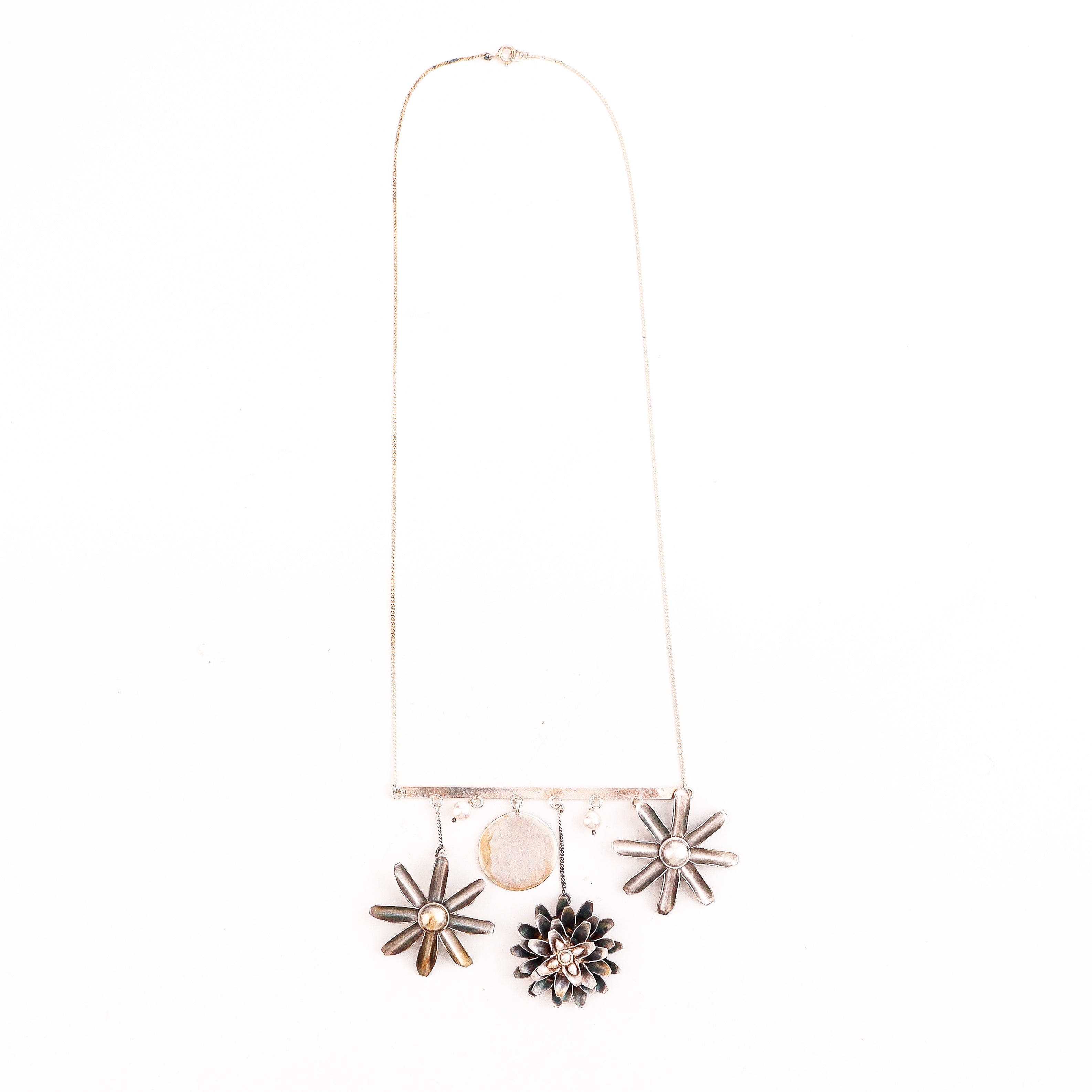 Detail shot of filigree snowflake motif and pearl latkan