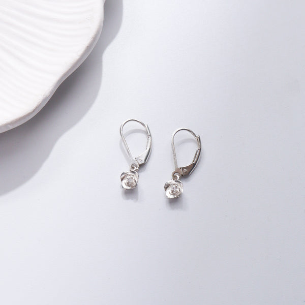 Silver CZ floral earrings on white background
