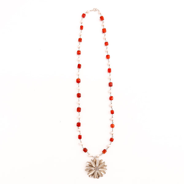 Close-up of Carnelian and Pearl beaded necklace with sunflower pendant