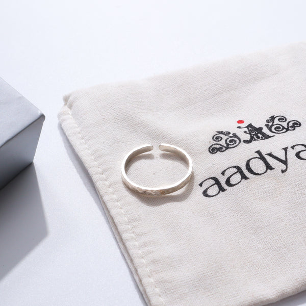 Unisex hammered silver ring on fabric