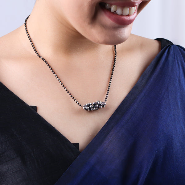 Sterling silver black bead necklace with floral cluster pendant