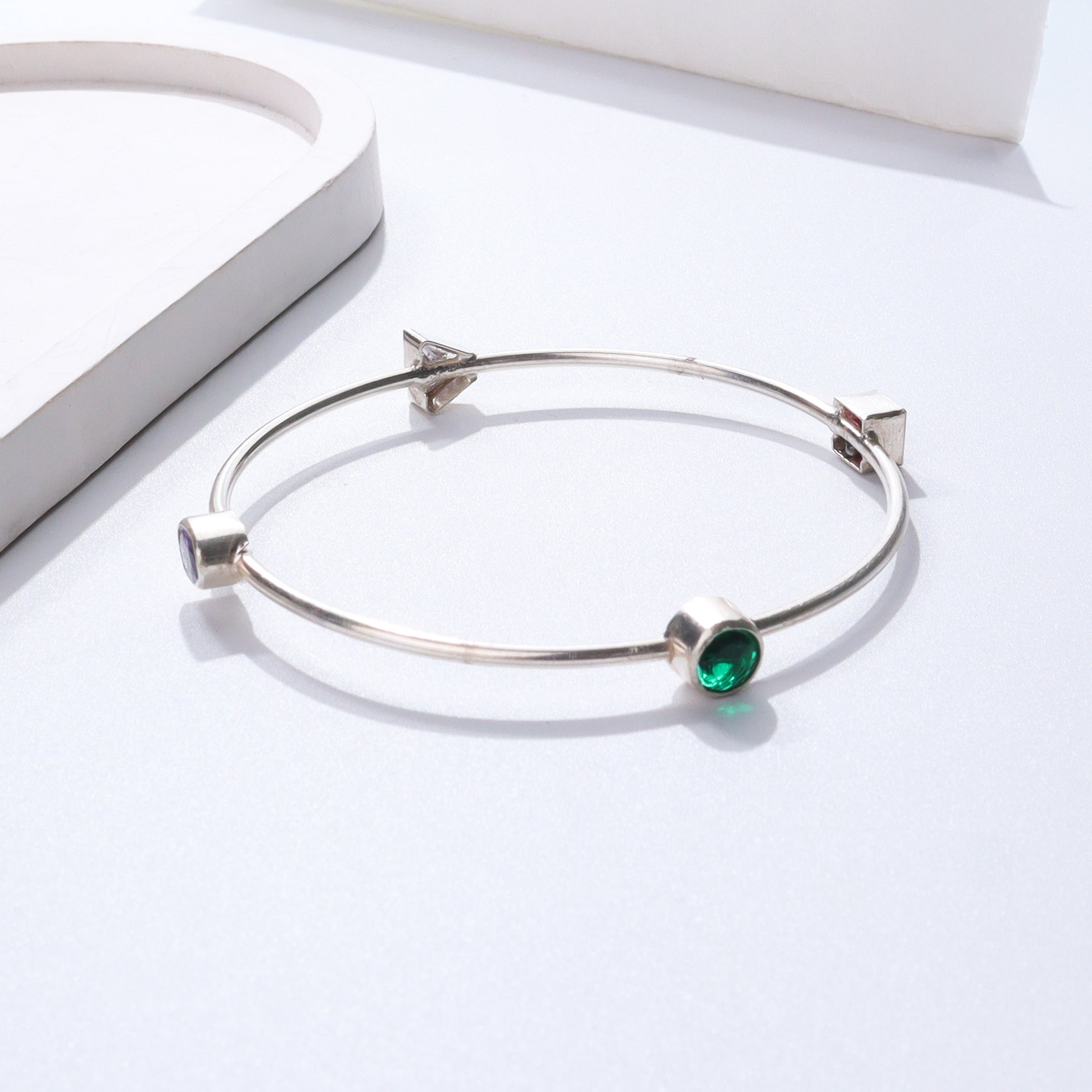 Silver bracelet with green gemstone