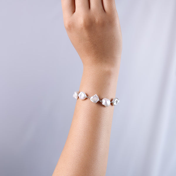 Pearl Ganthan bracelet worn on wrist with hand model