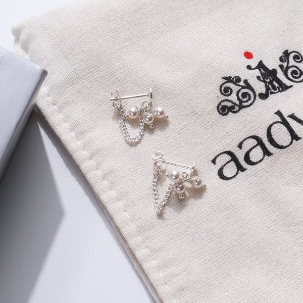 Pearl Bunch Trinket Earrings with silver chains and pearls on a fabric pouch