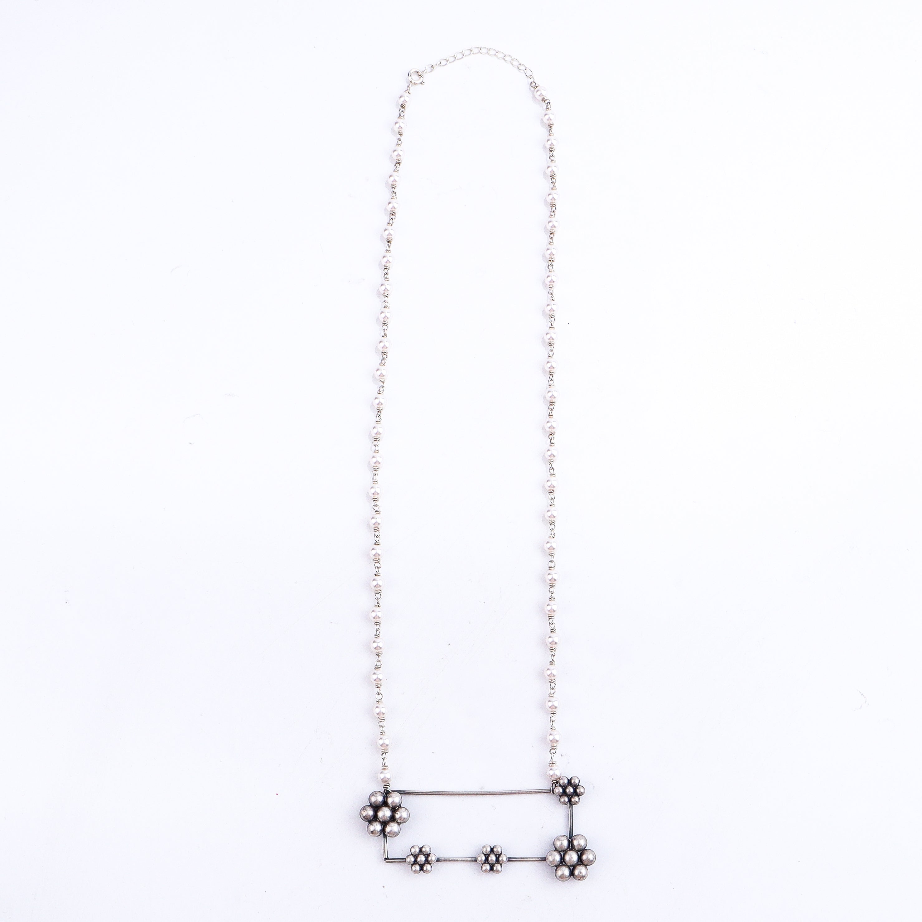 Flat-lay handmade kudi abstract silver necklace with pearls