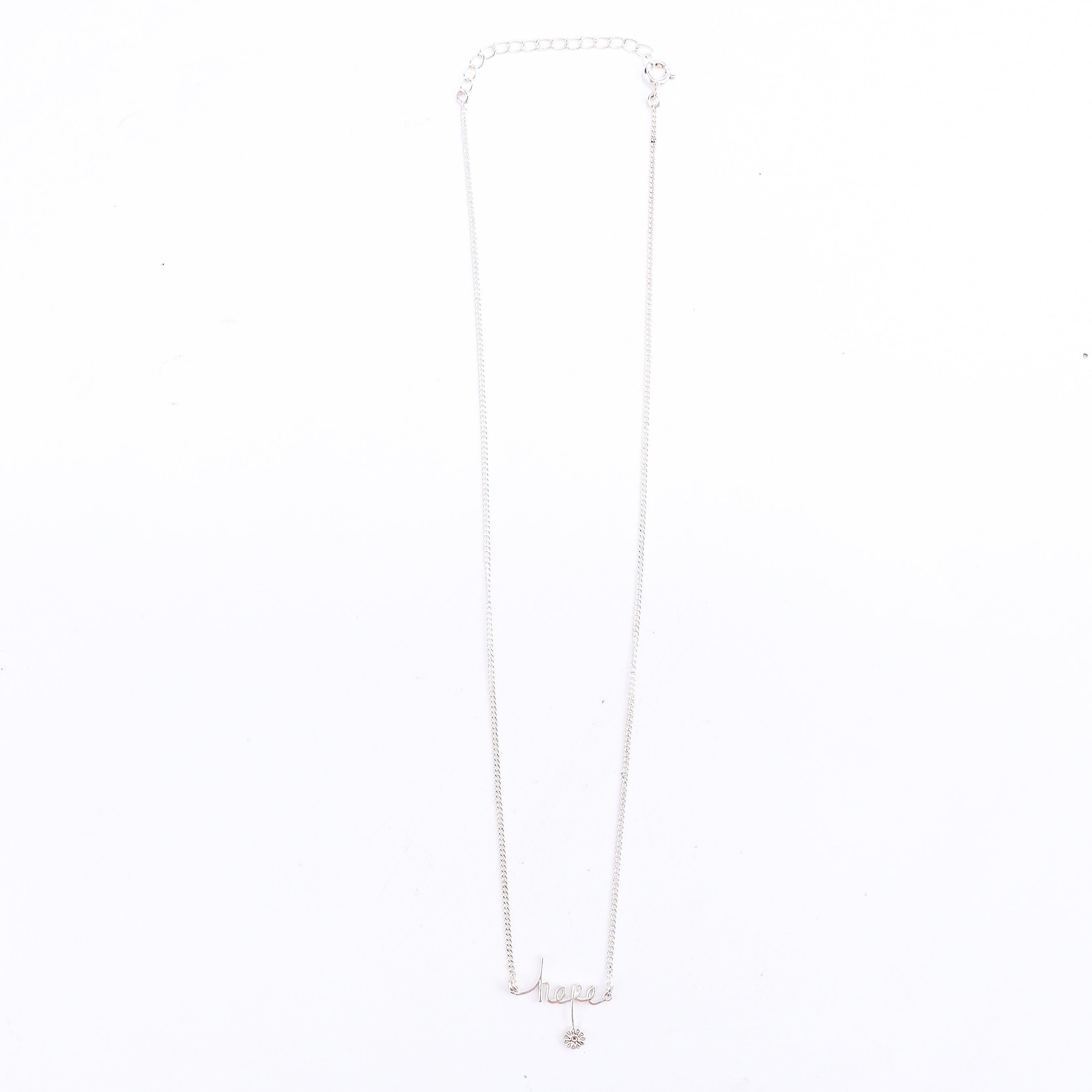 Detail shot highlighting polished silver finish of hope pendant