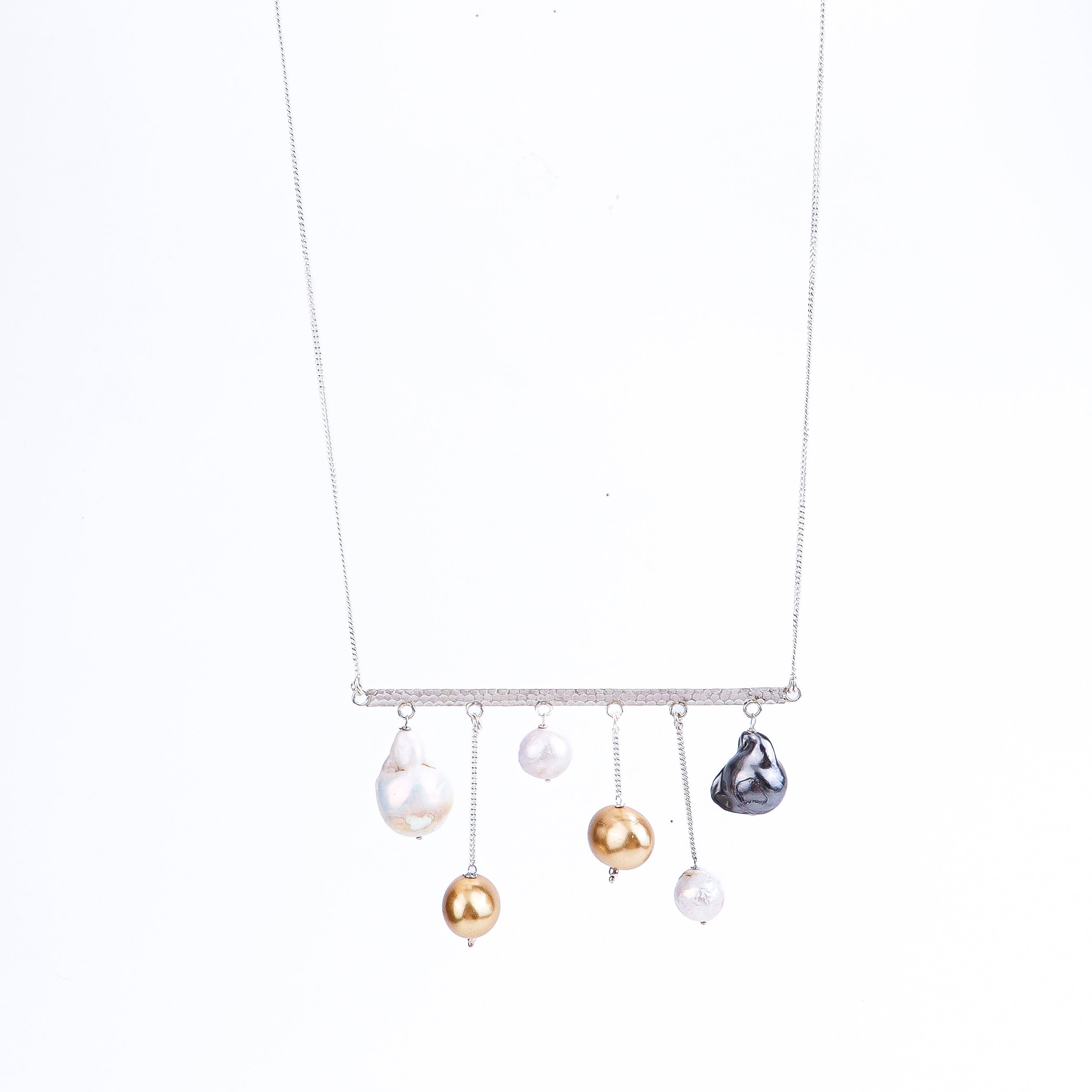 Detail shot highlighting free-form silver design and pearl lustre