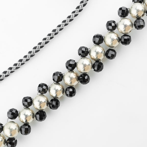 Detail shot of silver bead thushi pattern and spinel accents