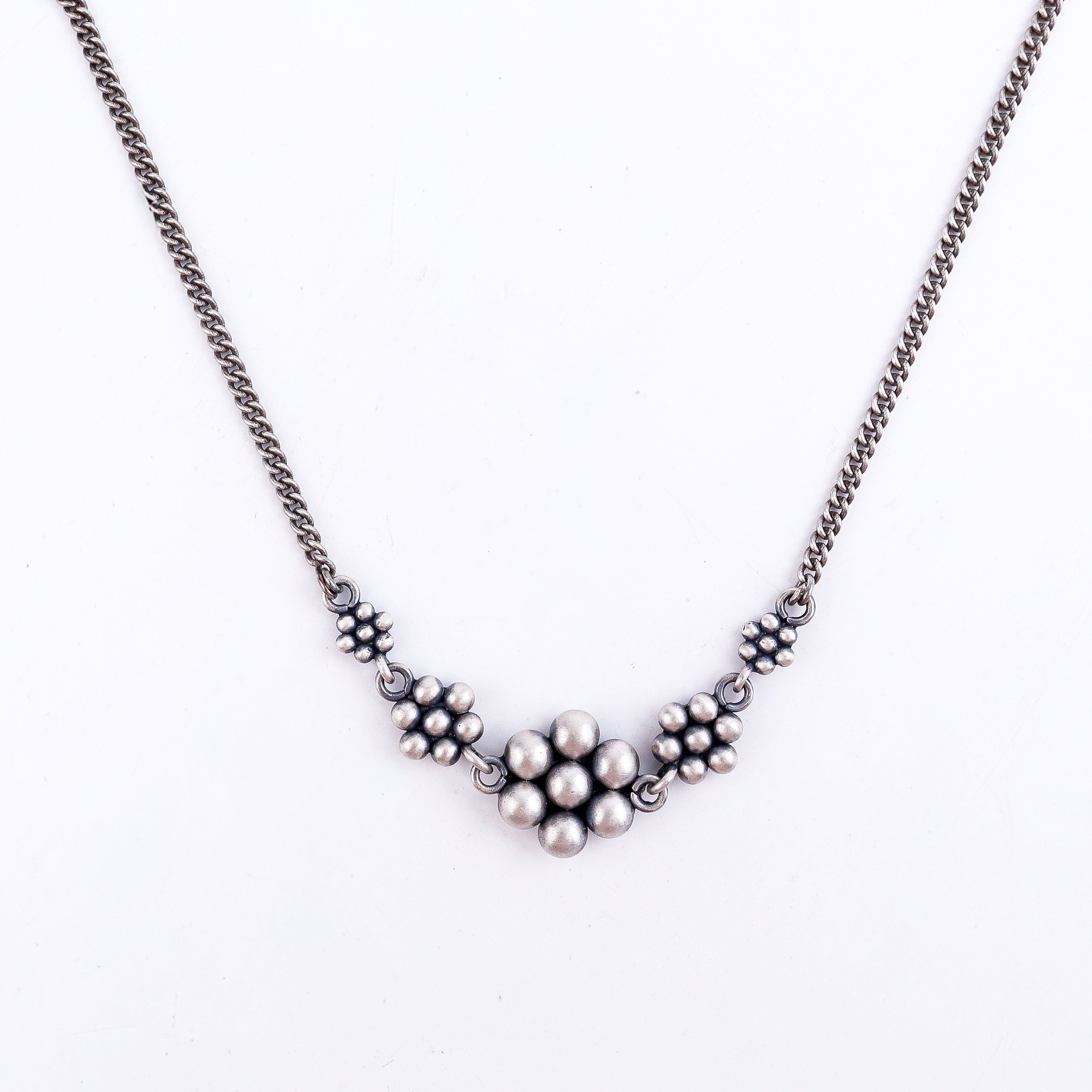 Detail shot highlighting handcrafted silver kudi elements