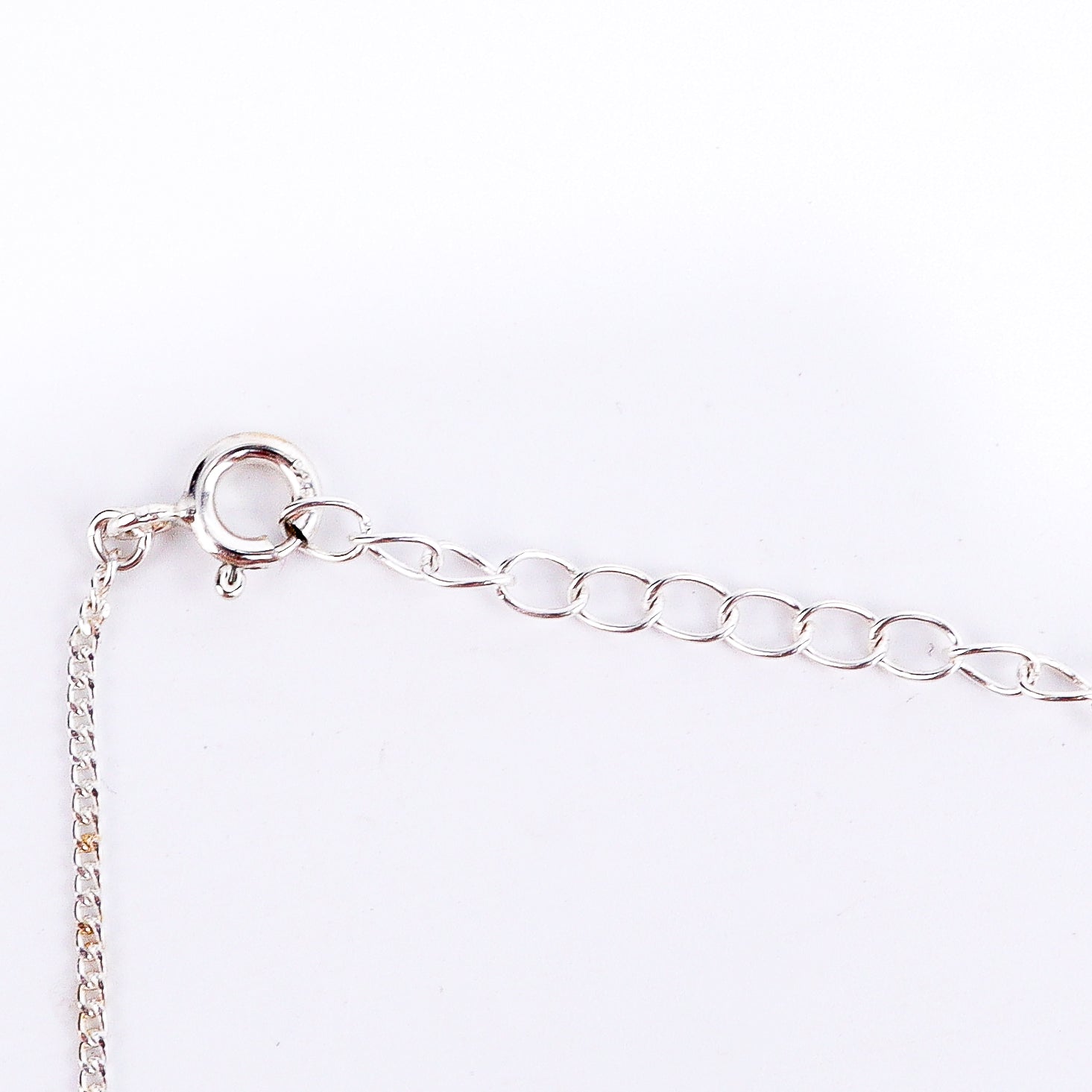 Evil eye silver necklace styled with modern outfit