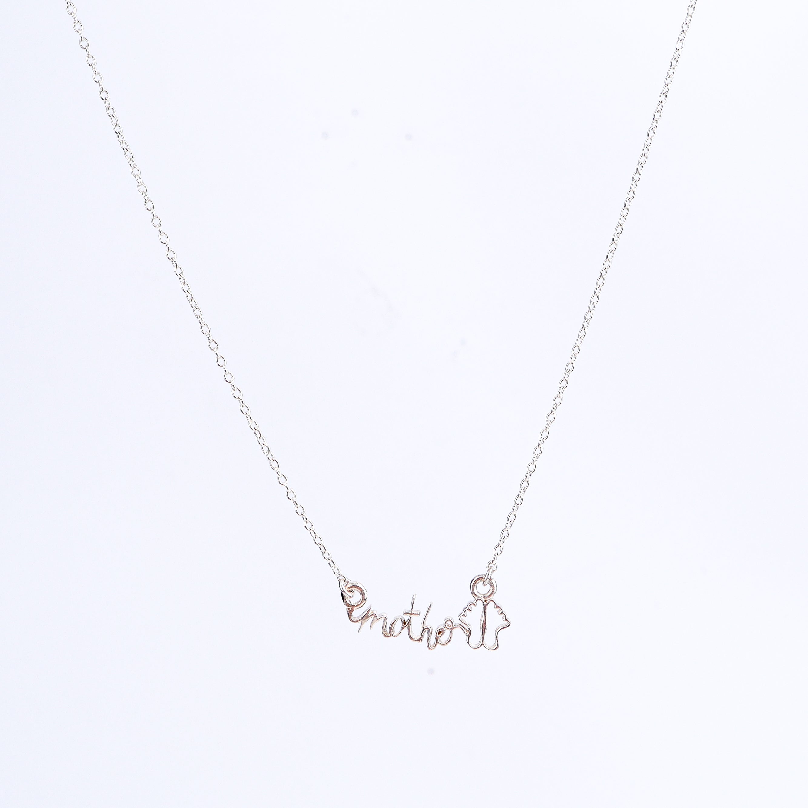 Detail shot highlighting polished silver finish of mother pendant