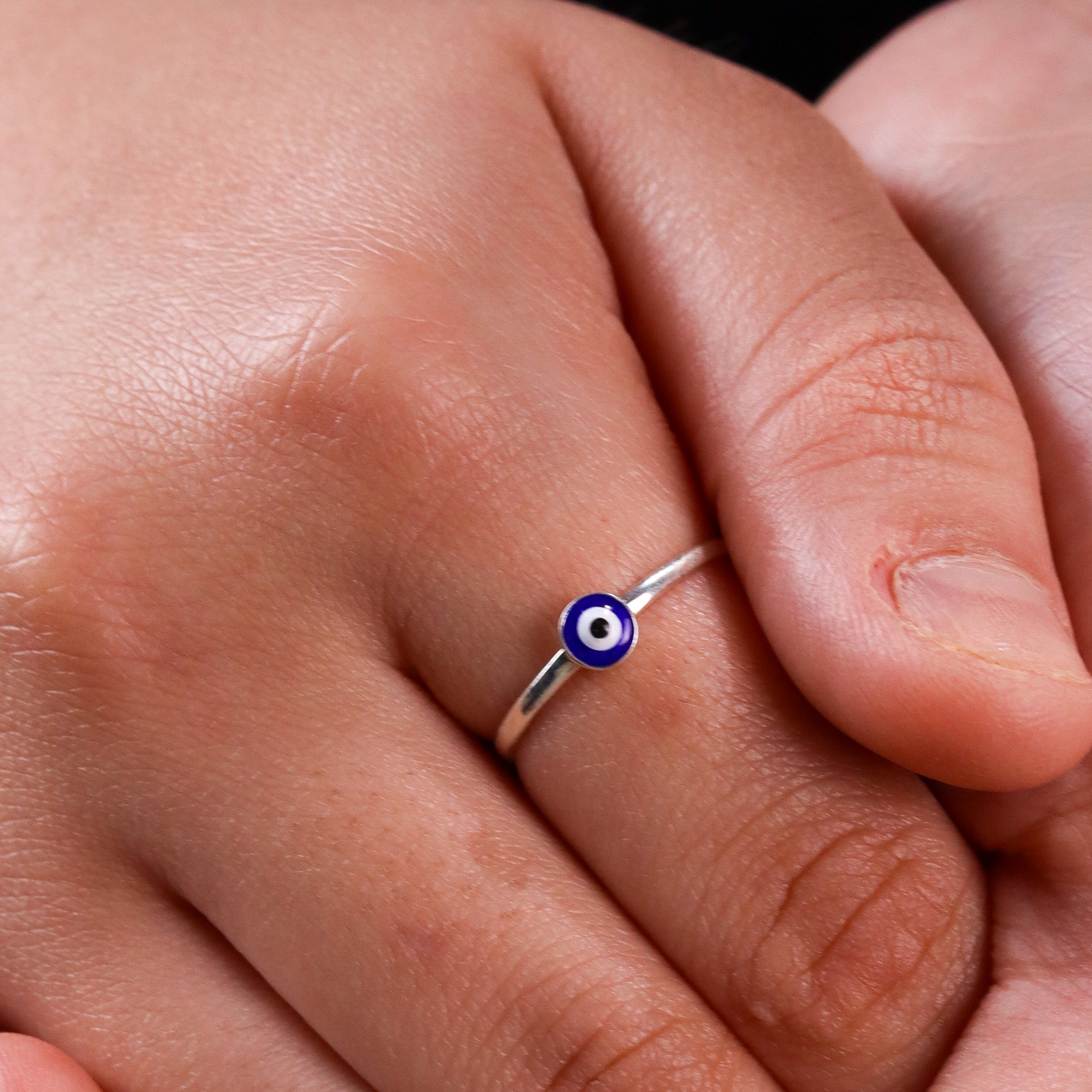 Close-up of silver evil eye ring