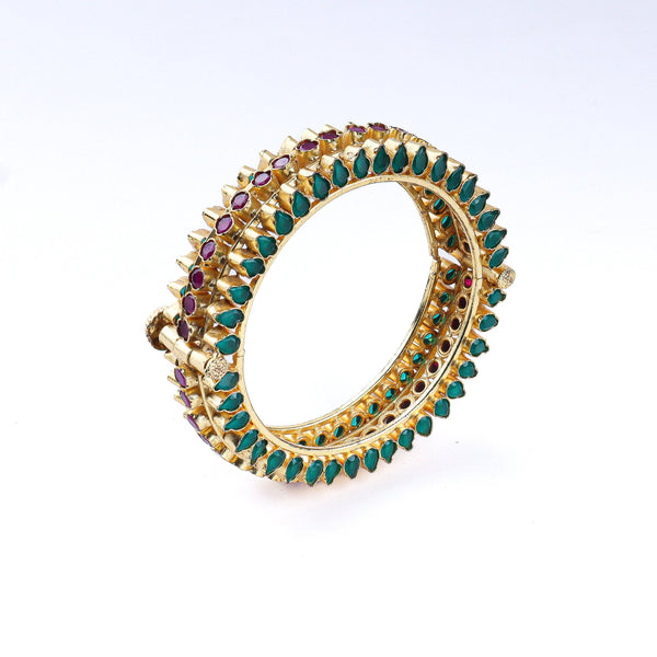 Angled view of a 22K gold-plated fashion bangle (single) highlighting its elegant structure, unique design, and polished gold finish