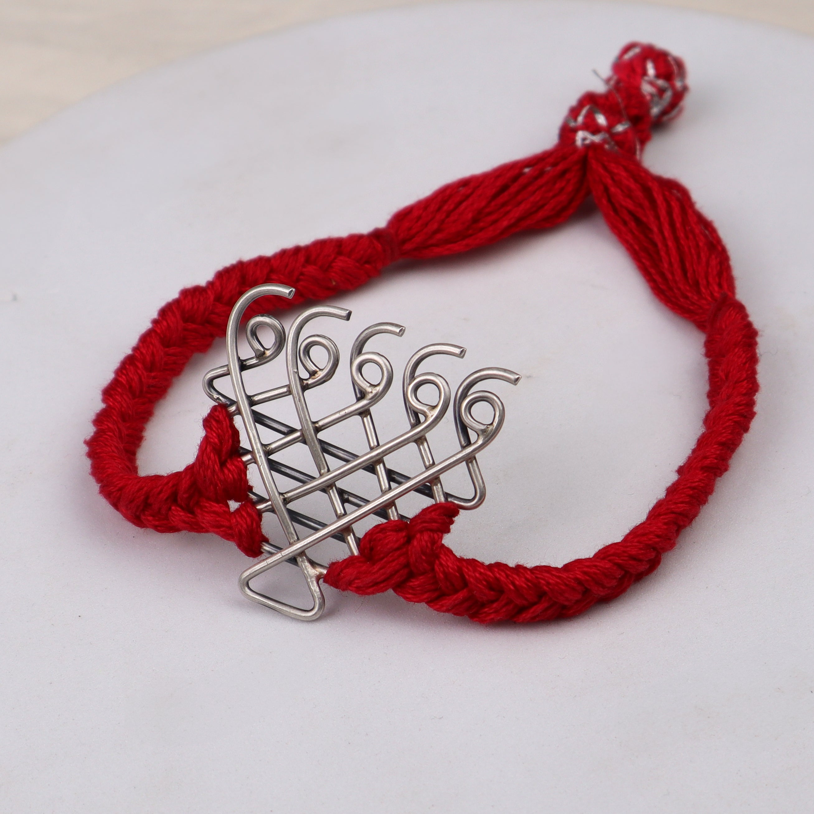 Handcrafted silver Saraswati bracelet red thread polished finish