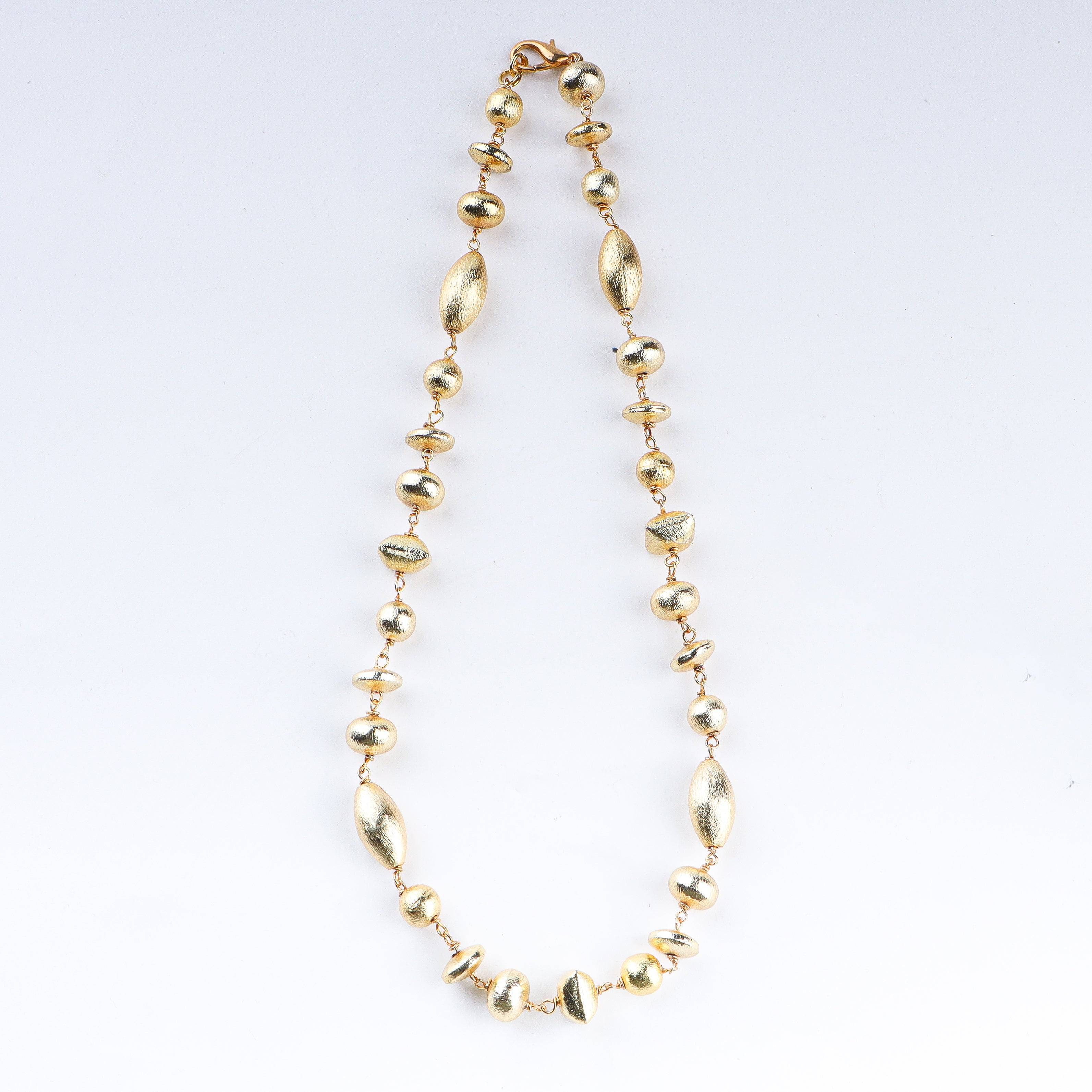Close-up of 22K gold-plated fashion necklace showcasing intricate detailing, fine craftsmanship, and rich 22K gold plating