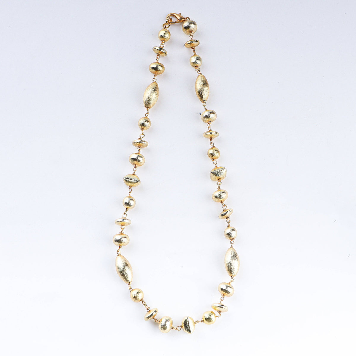 Close-up of 22K gold-plated fashion necklace showcasing intricate detailing, fine craftsmanship, and rich 22K gold plating