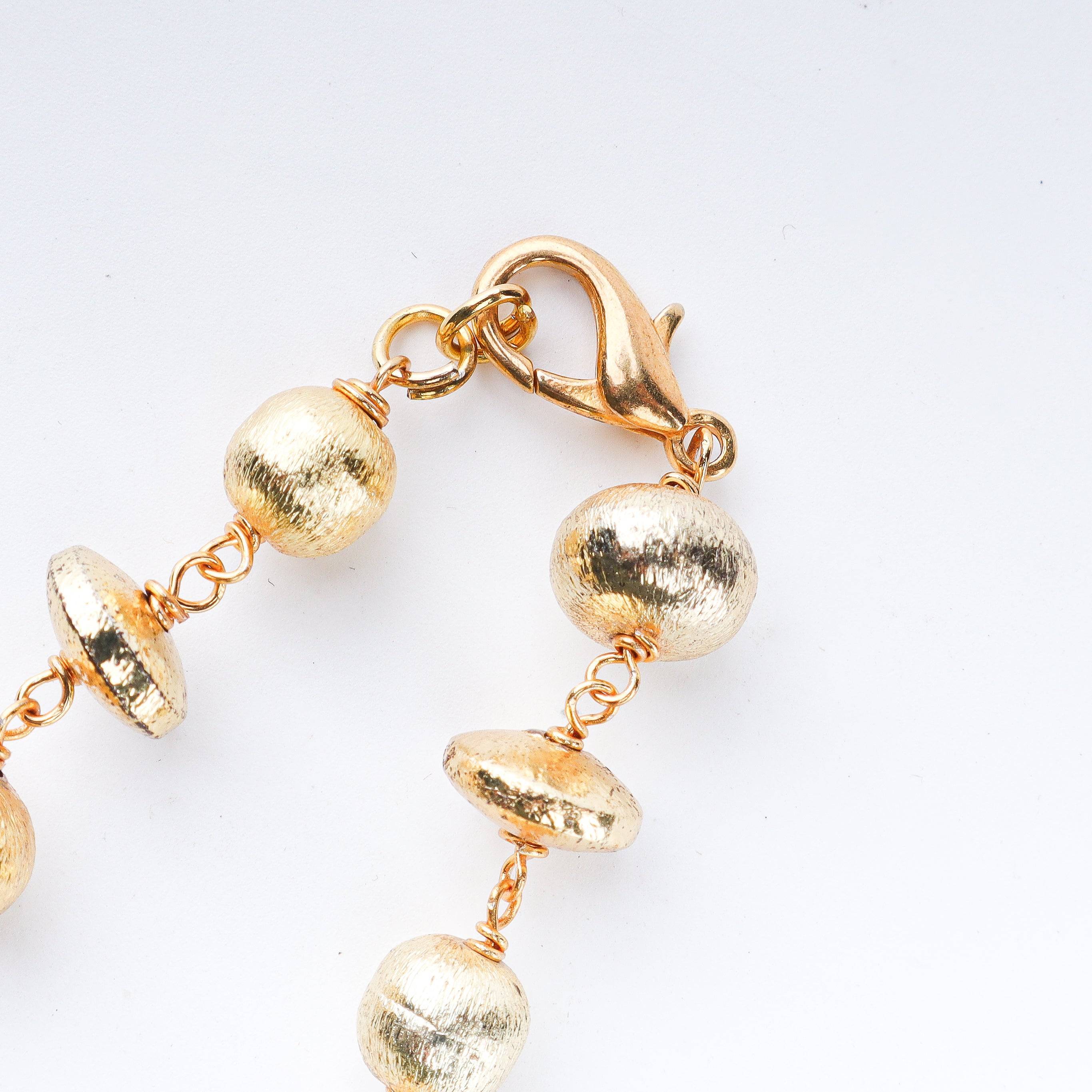 Model styling 22K gold-plated fashion necklace with an elegant ethnic outfit for a graceful festive jewelry look