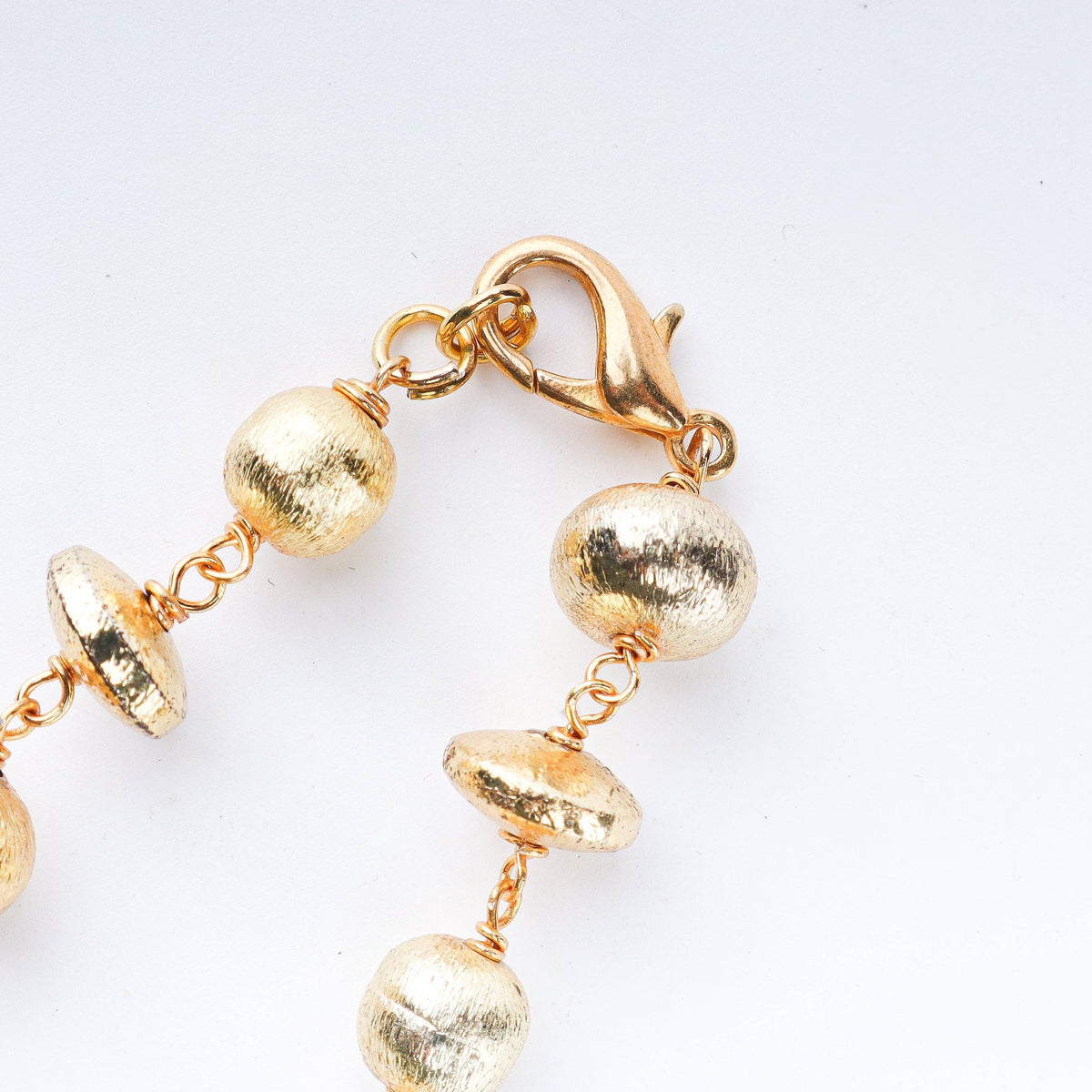 Model styling 22K gold-plated fashion necklace with an elegant ethnic outfit for a graceful festive jewelry look