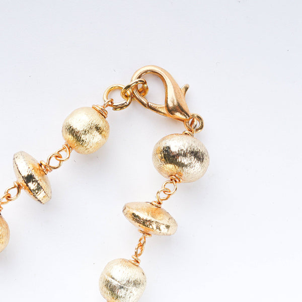 Model styling 22K gold-plated fashion necklace with an elegant ethnic outfit for a graceful festive jewelry look