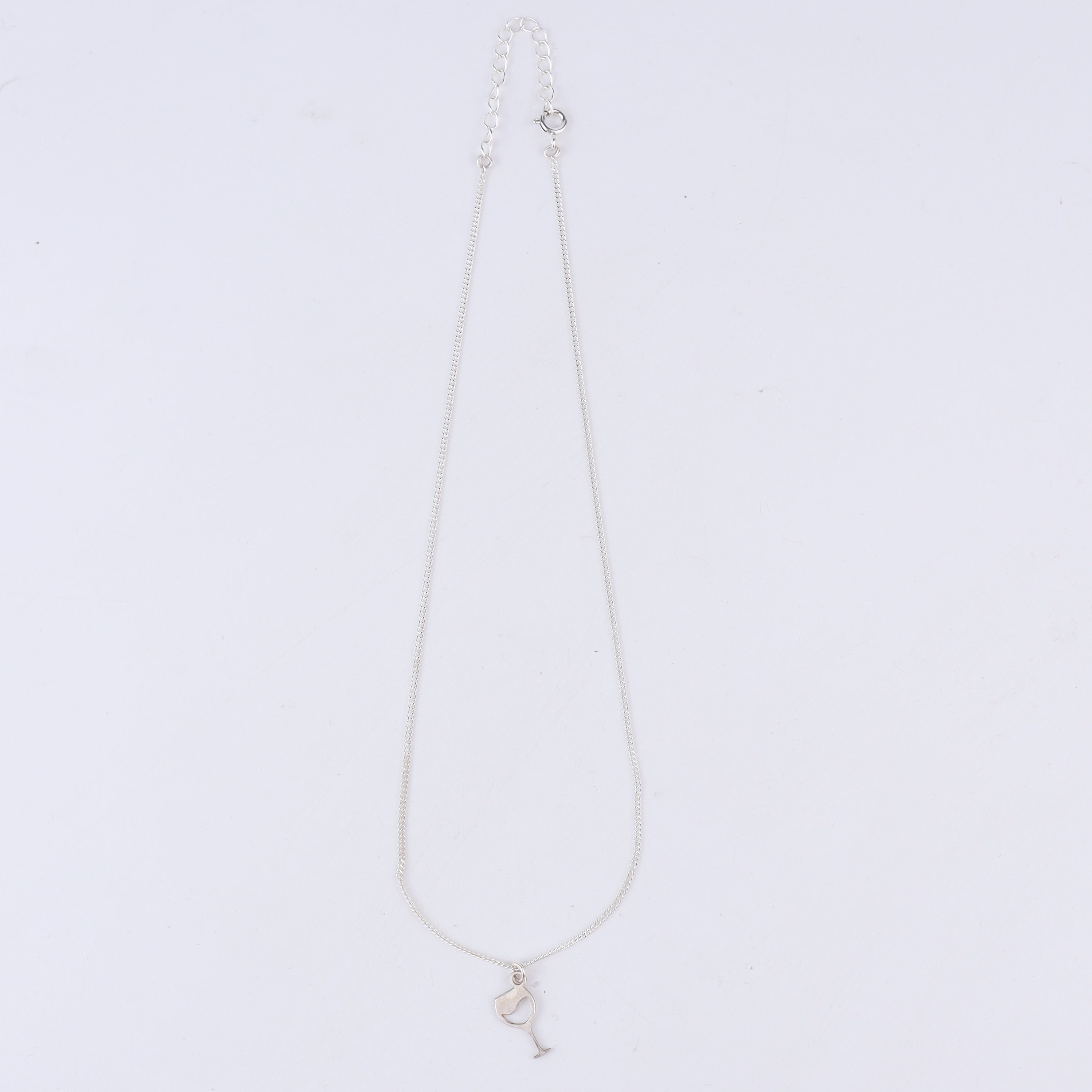 Wine glass silver pendant styled with dress and modern outfit