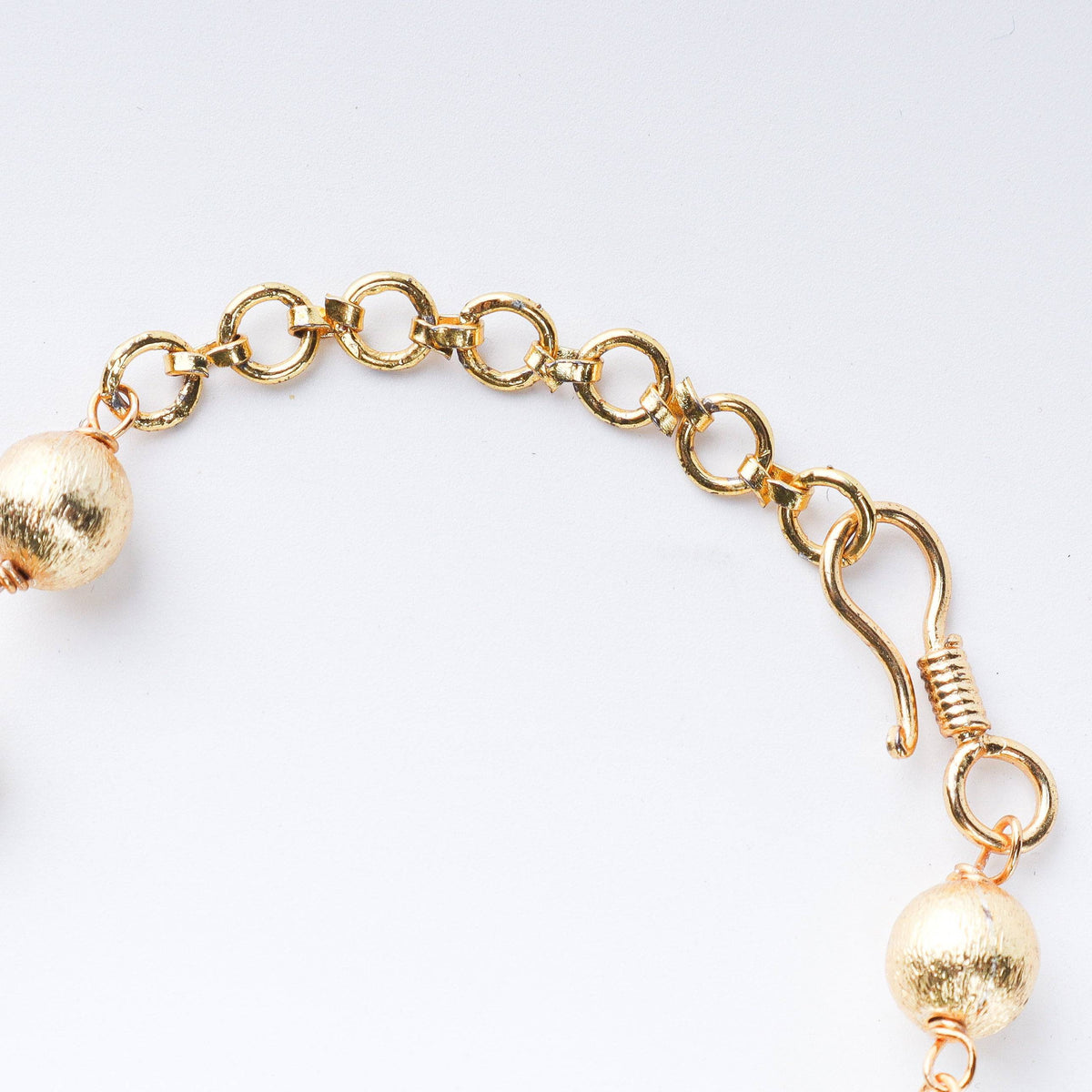 Angled view of 22K gold-plated fashion necklace highlighting its elegant structure, design, and polished gold finish