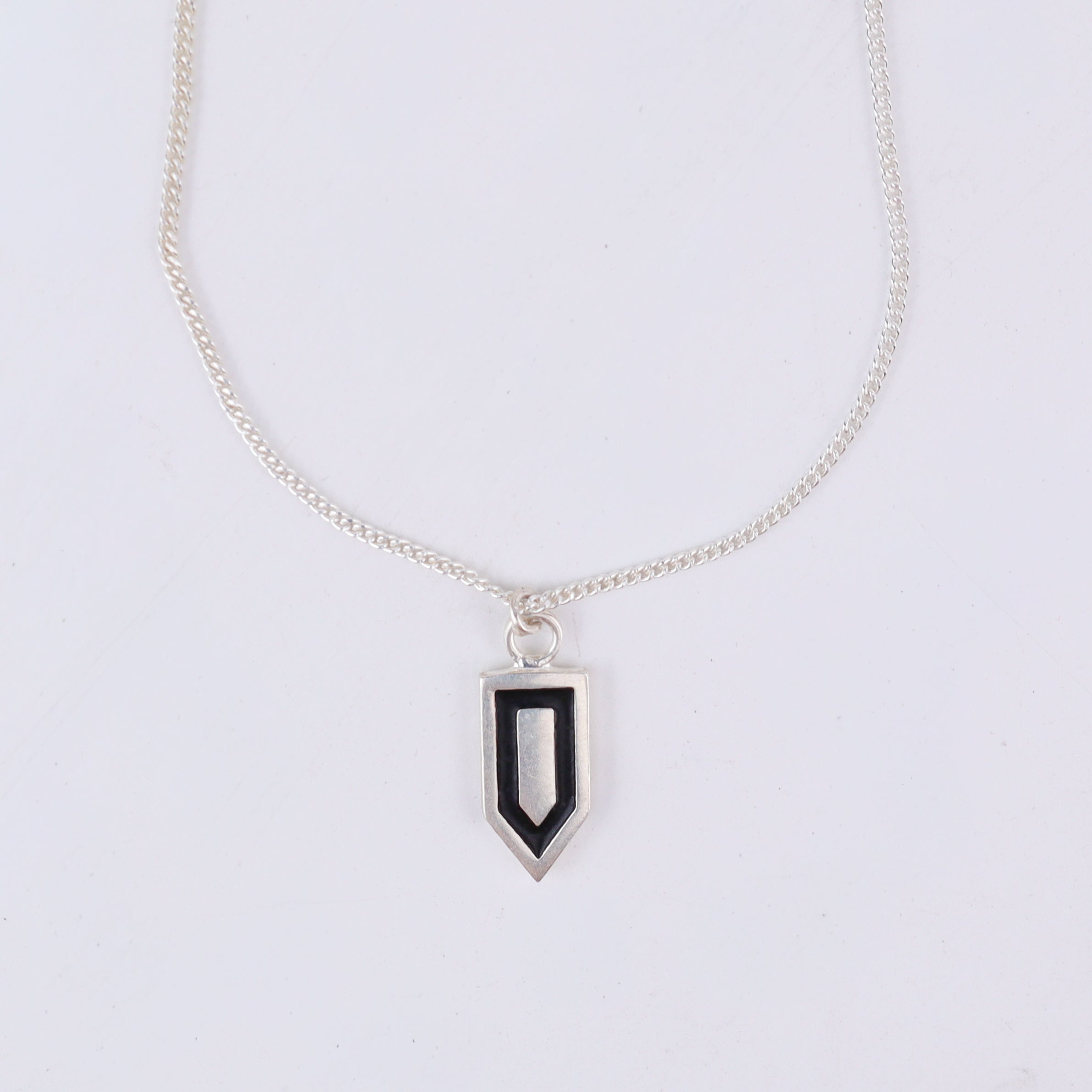 Tie silver pendant styled with modern outfit