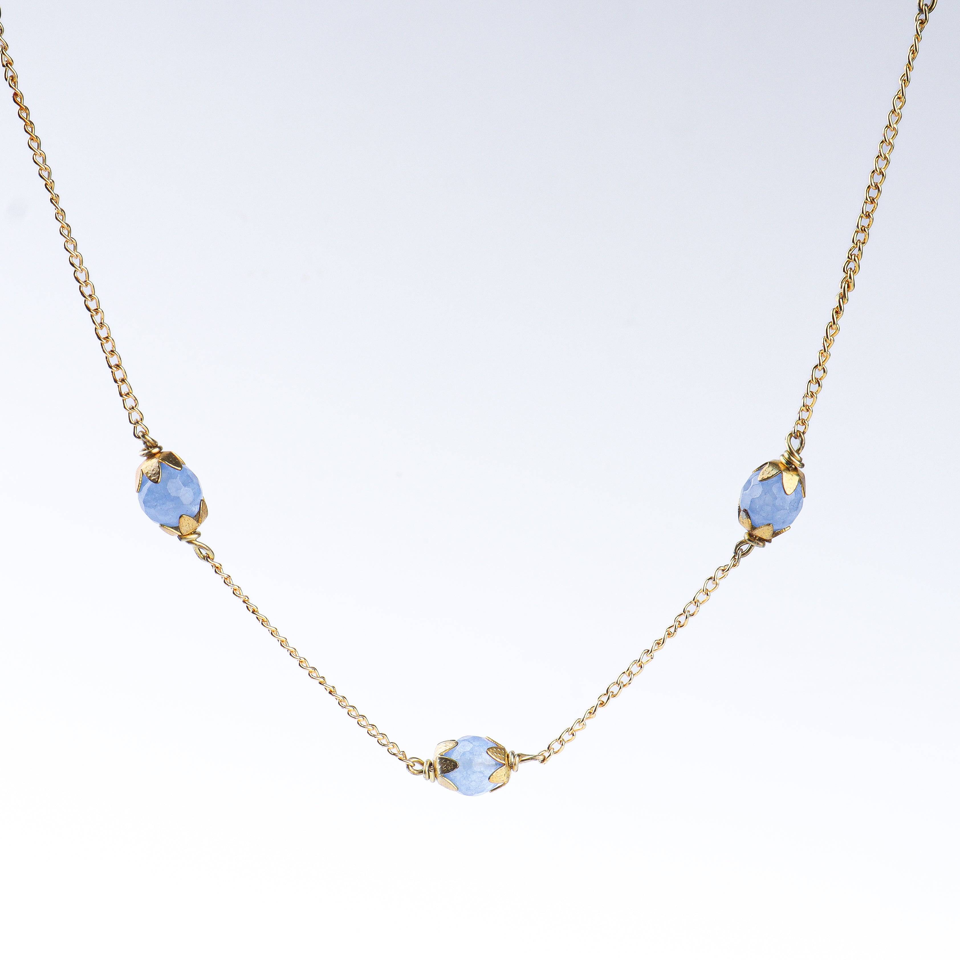 Angled view of a 22K gold-plated fashion necklace highlighting its elegant structure, design, and polished gold finish