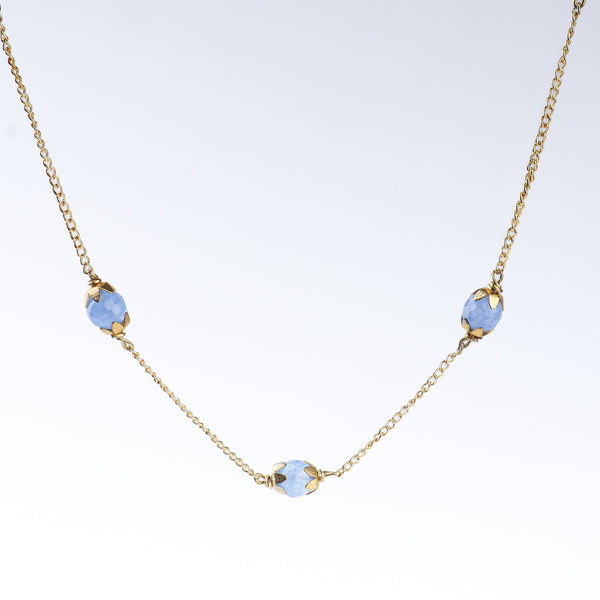 Angled view of a 22K gold-plated fashion necklace highlighting its elegant structure, design, and polished gold finish