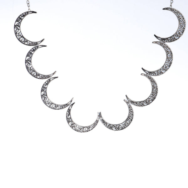 Flat-lay of a 22K gold-plated fashion necklace with complementary gold-plated jewelry and elegant accessories