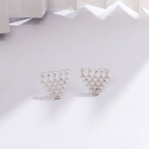 Silver earrings with small geometric motifs and embedded stones