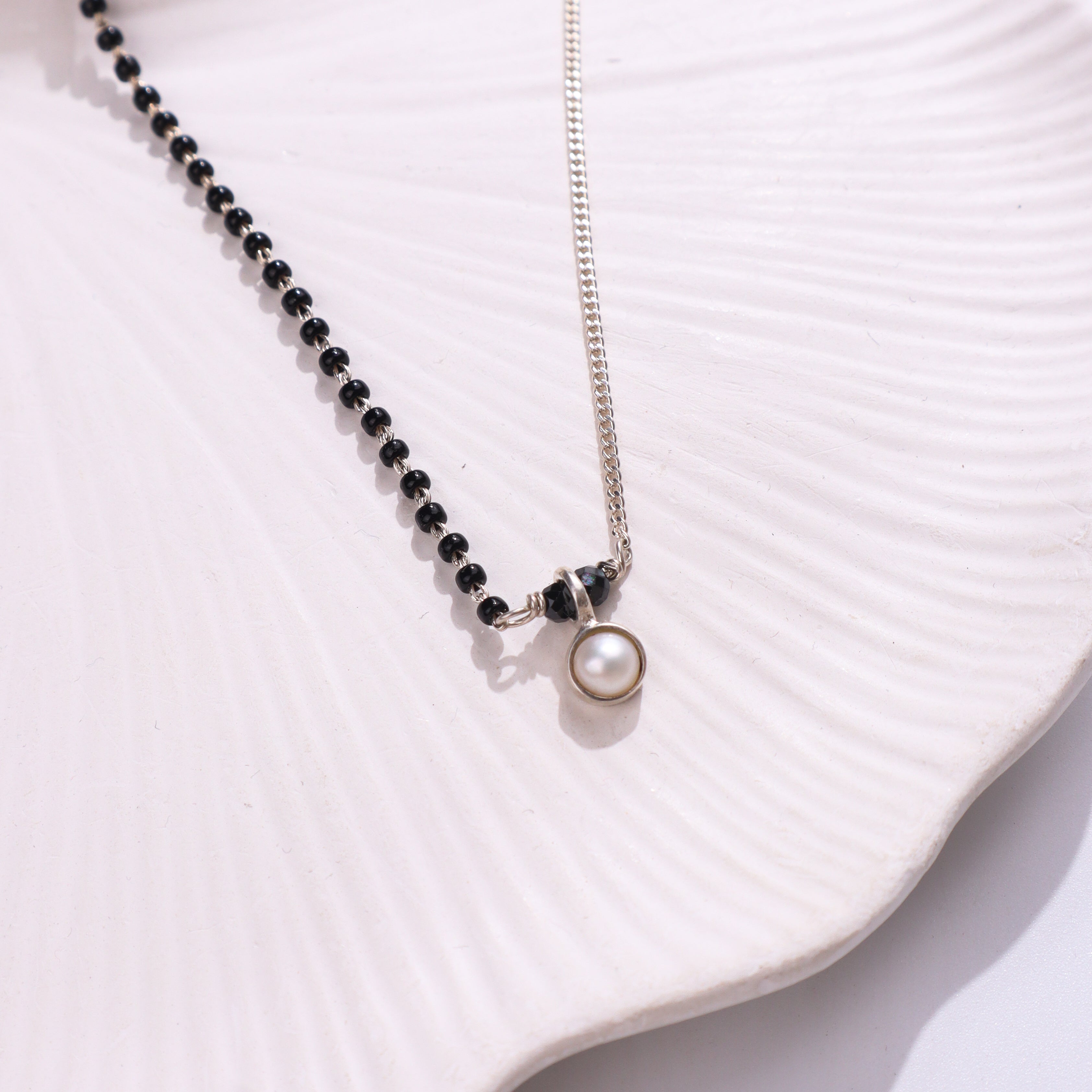 Silver and black beaded necklace with pearl pendant
