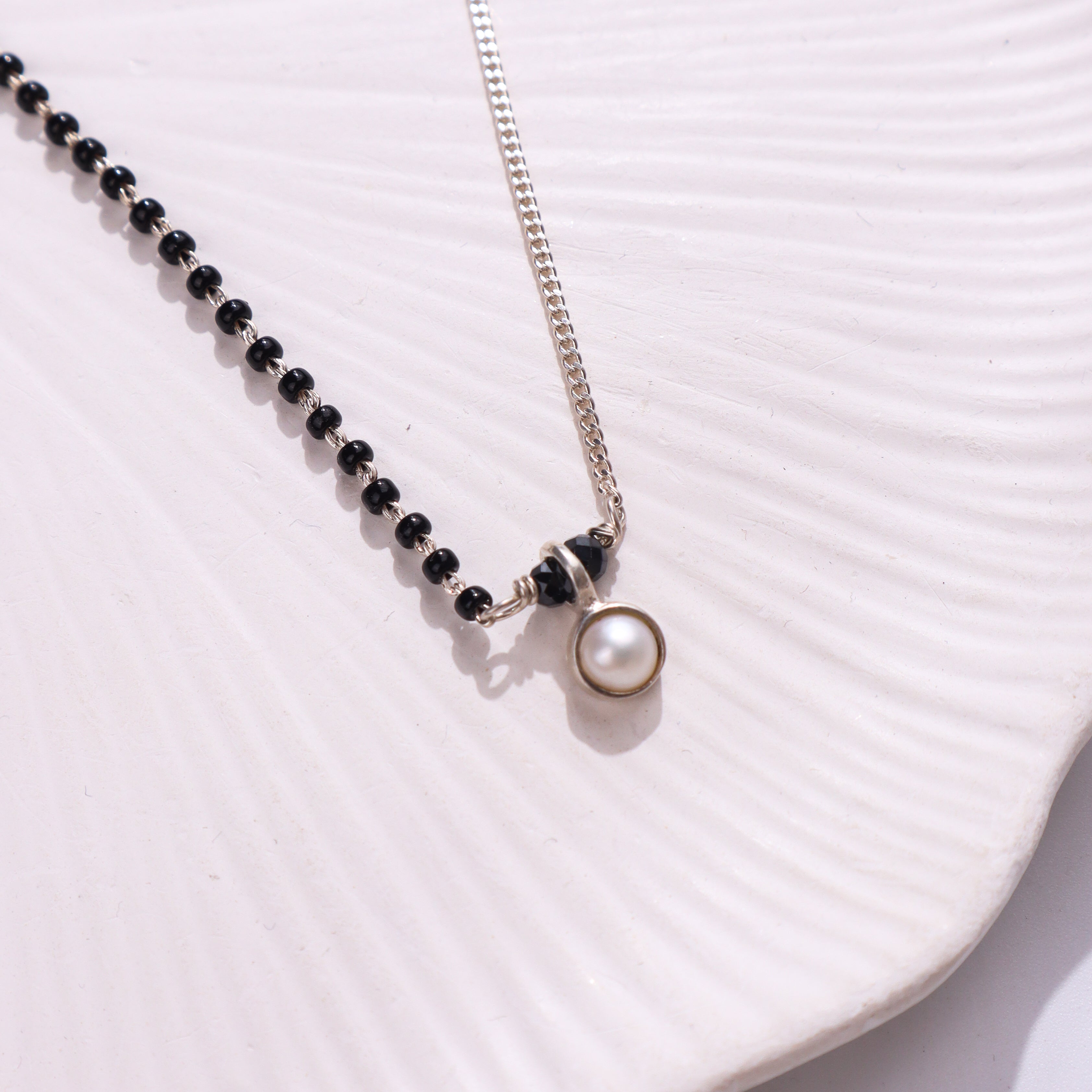 Silver and black beaded necklace with pearl pendant