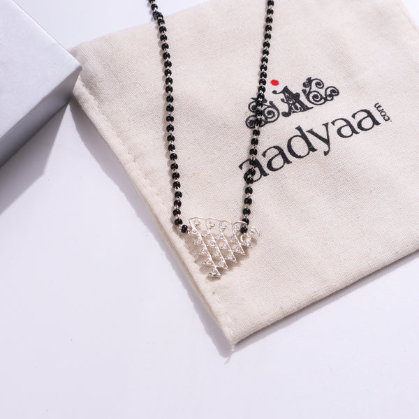 Silver CZ Saraswati Mangalsutra with black beads on beige fabric
