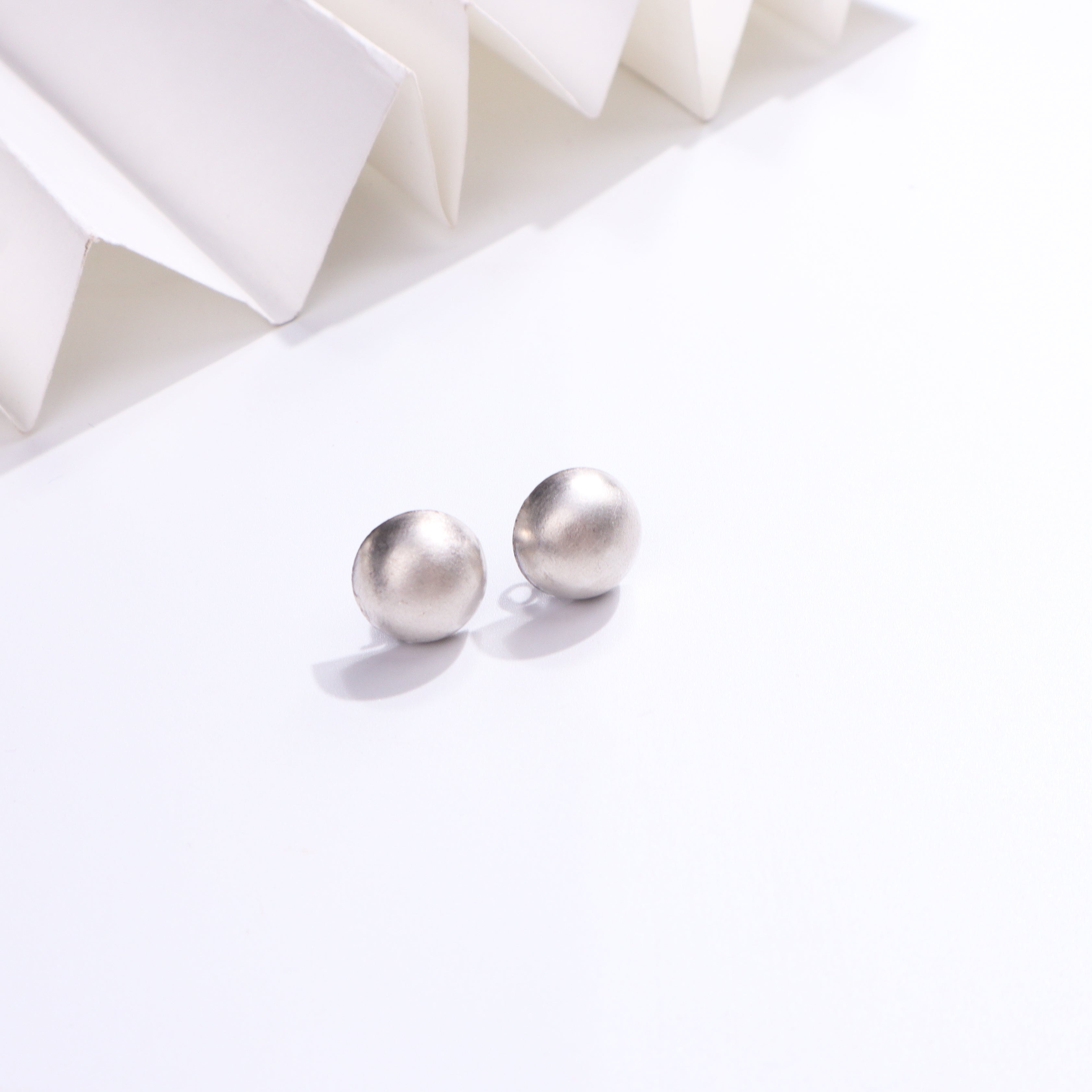 Silver oxidized small dome earrings with a smooth finish