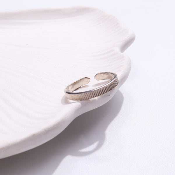 Unisex Silver Ring on white textured background