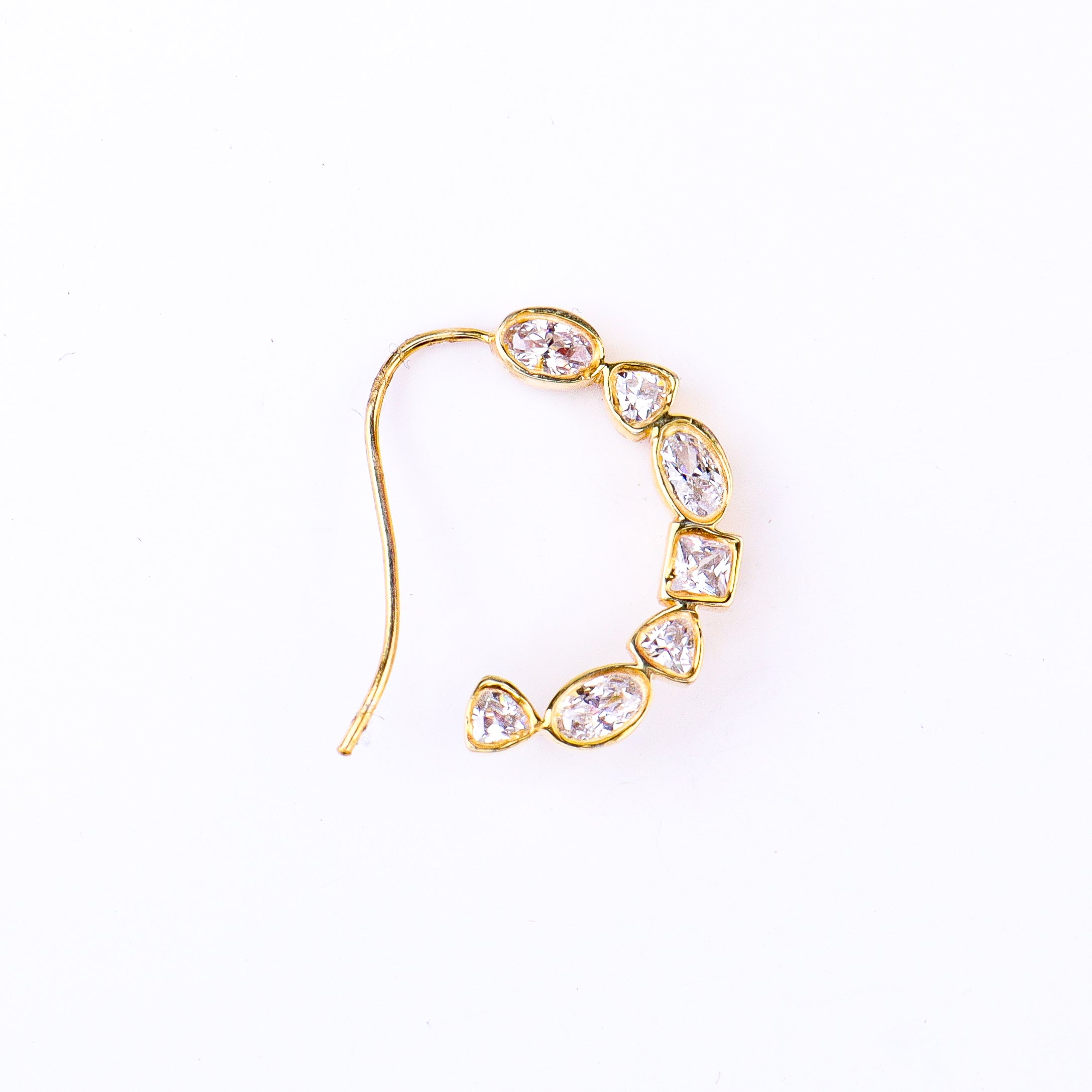 Flat-lay silver small nath stones left pierced on neutral background