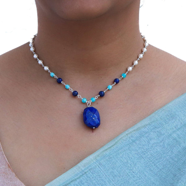 Close-up of silver pearl Ganthan necklace highlighting colorful stones and polished sterling silver craftsmanship