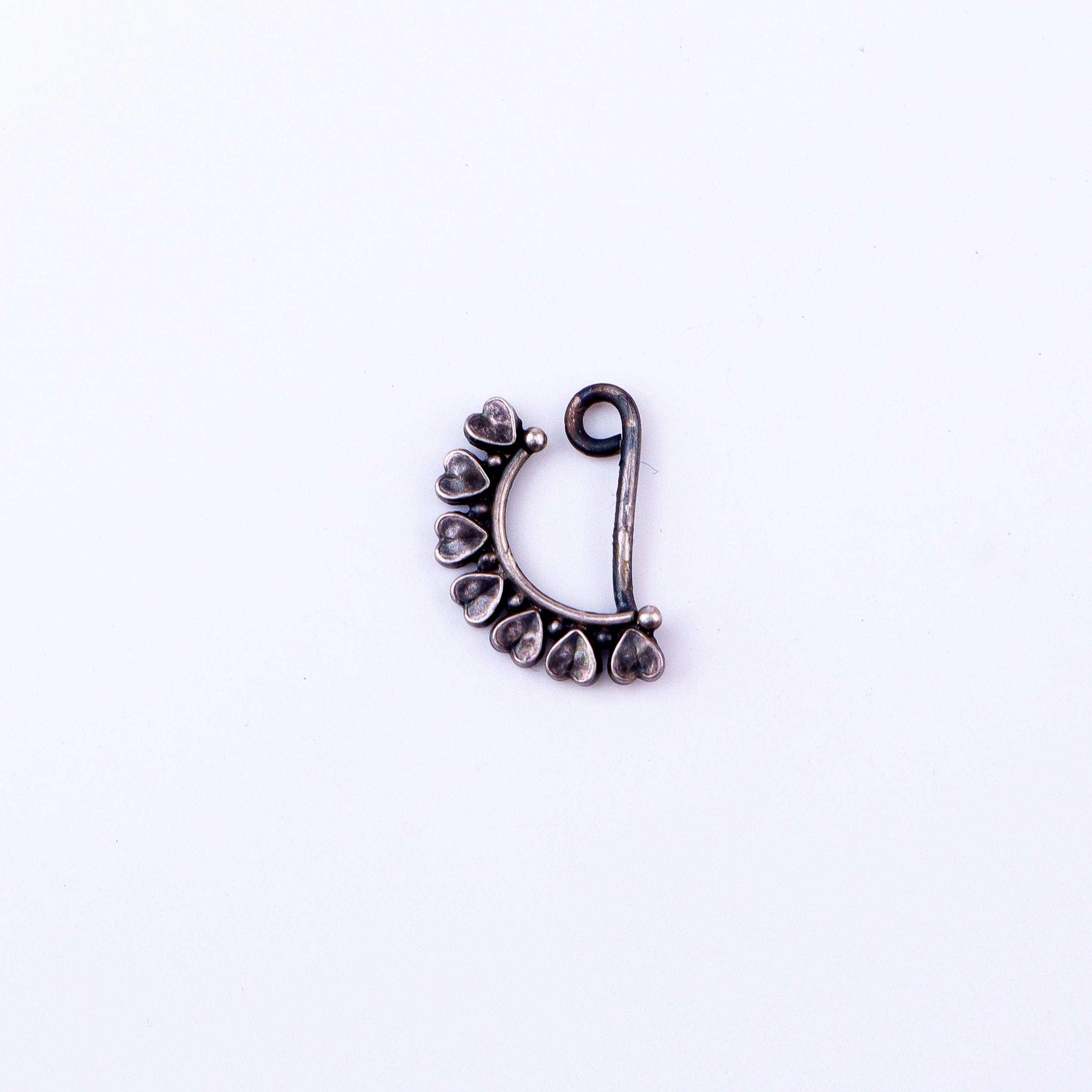 Flat-lay silver heart nath left clip on on neutral background