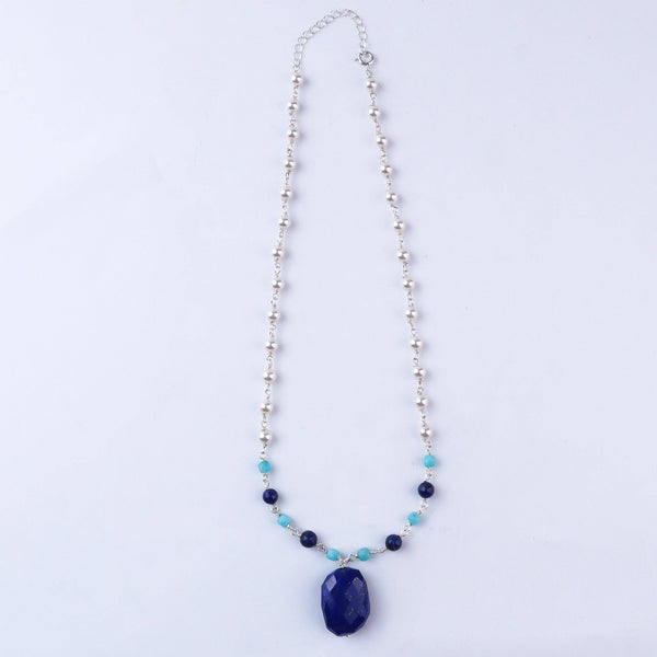 Model wearing silver pearl Ganthan necklace with multicolor stones for festive or wedding styling