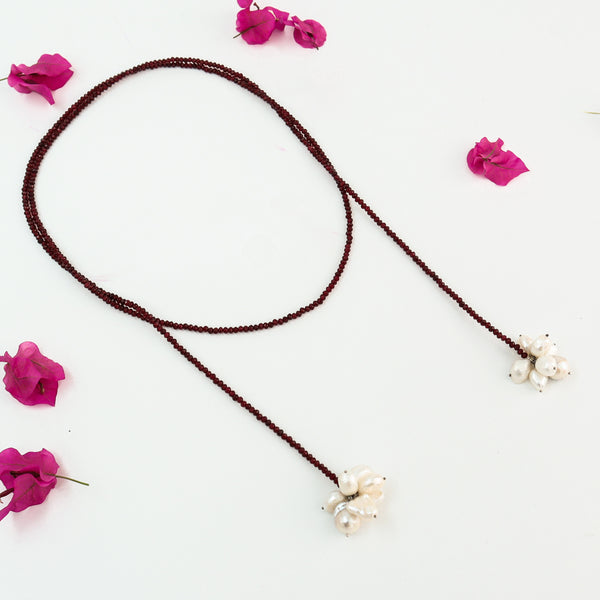 Red garnet beaded necklace with pearl cluster pendant on white background