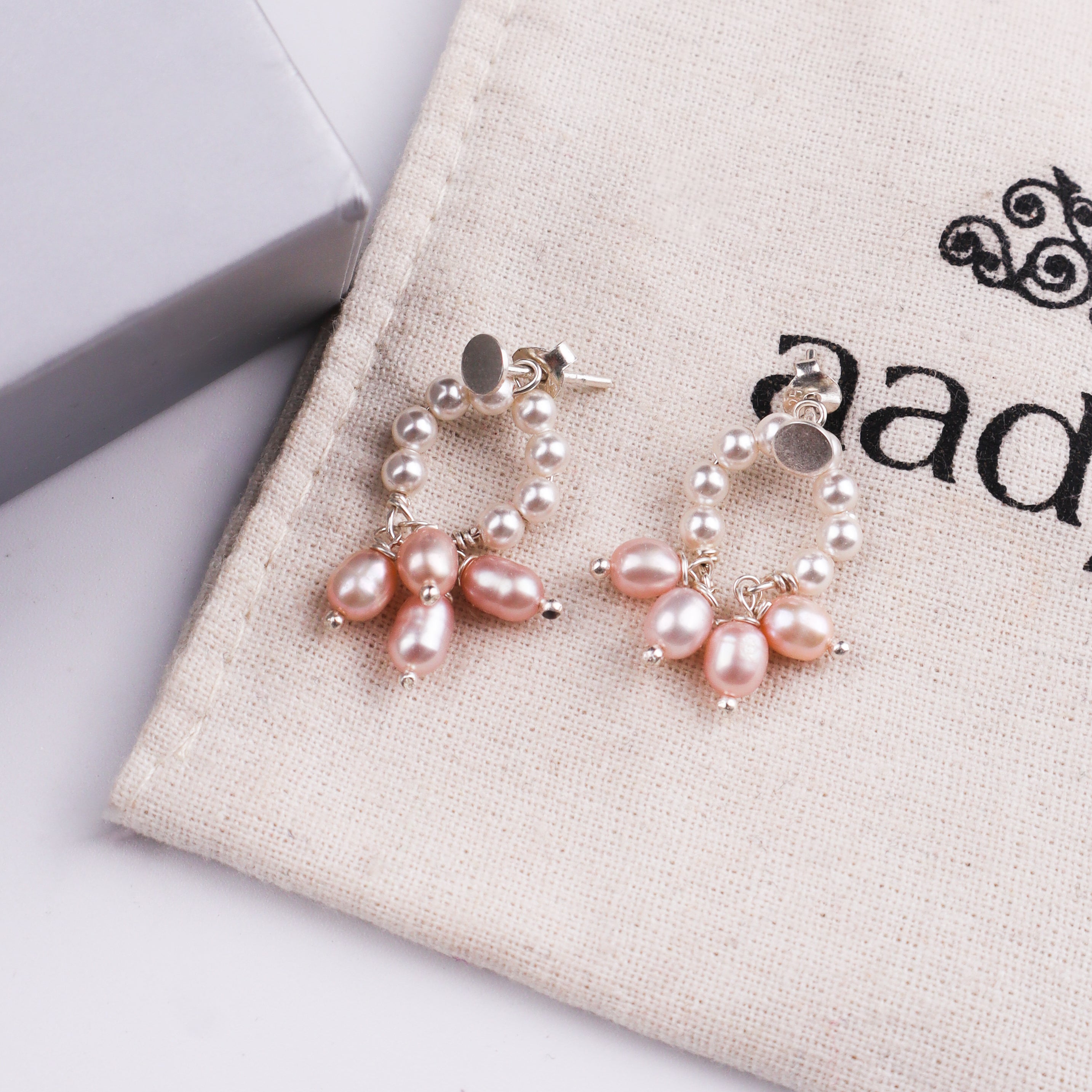 Earrings with pink pearls on jewelry box