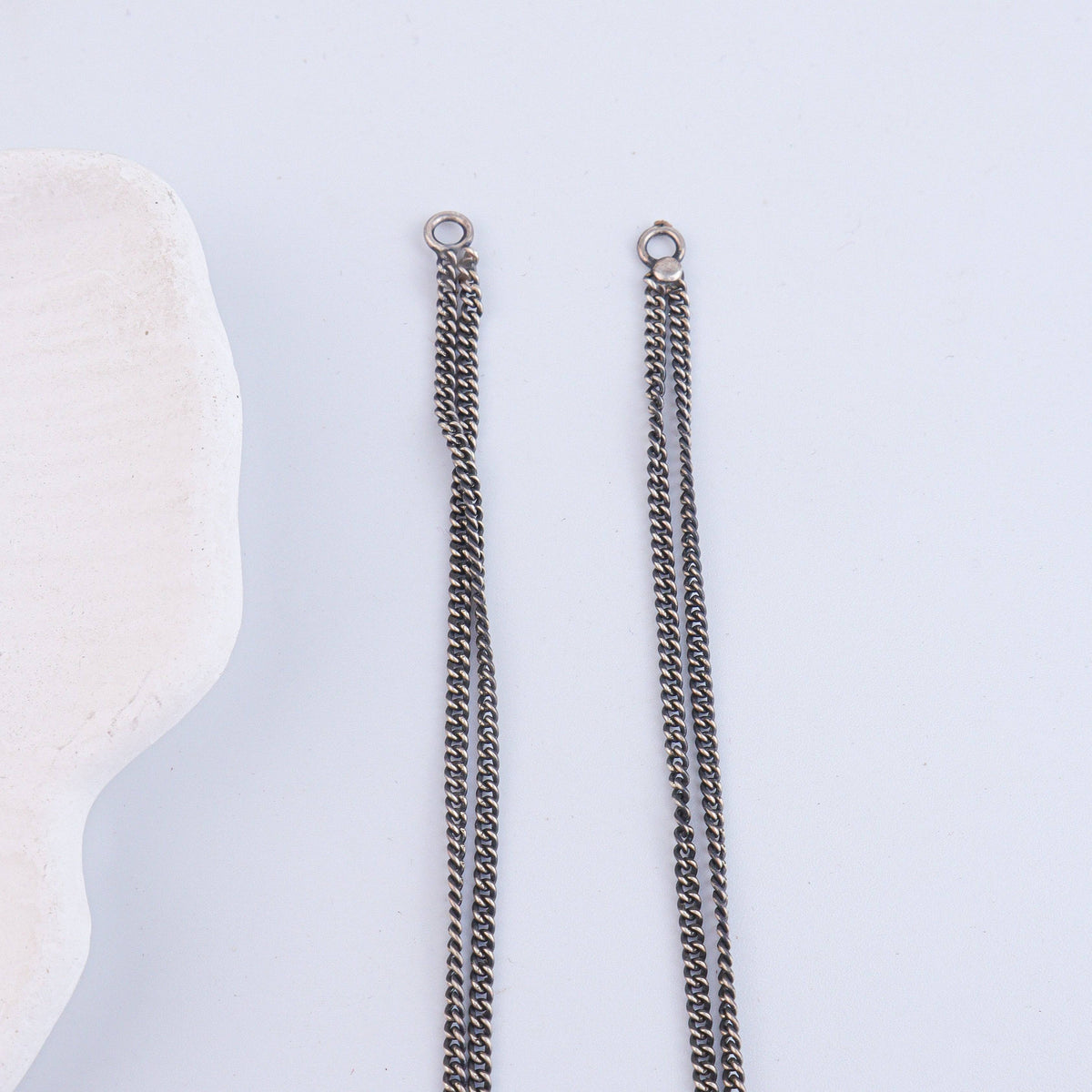 Flat-lay of Antique Silver Earrings with traditional accessories and complementary silver jewelry