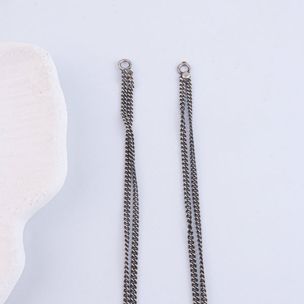 Flat-lay of Antique Silver Earrings with traditional accessories and complementary silver jewelry