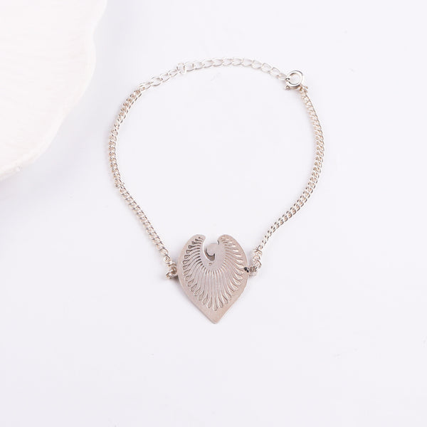 Silver chain bracelet with leaf pendant on white background