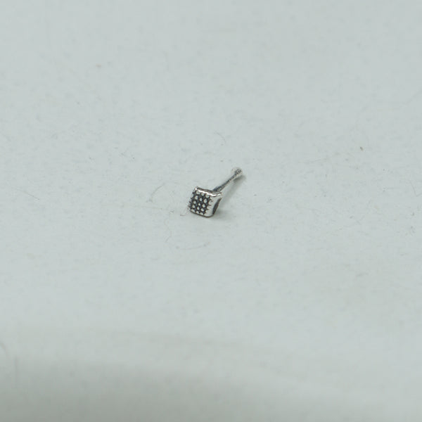 Silver dotted diamond nose pin on white background
