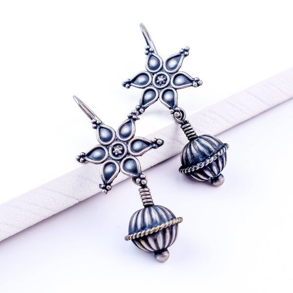 Angled side view of Oxidized Flower Spring Dome Earrings