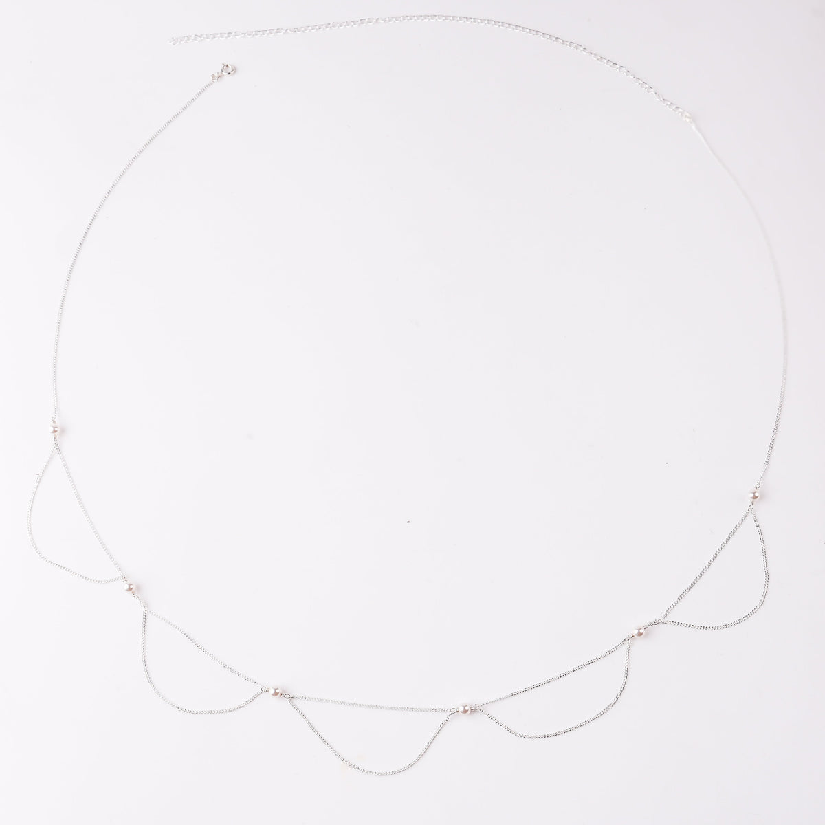 Elegant pearl and silver necklace on white background