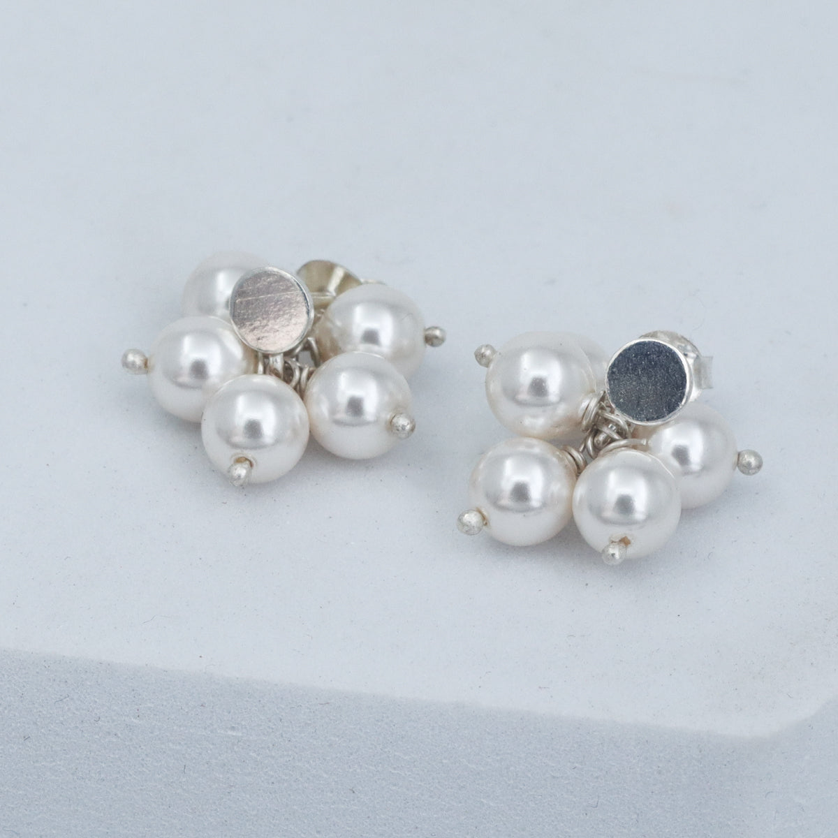 Child wearing pearl bunch stud earrings comfortably