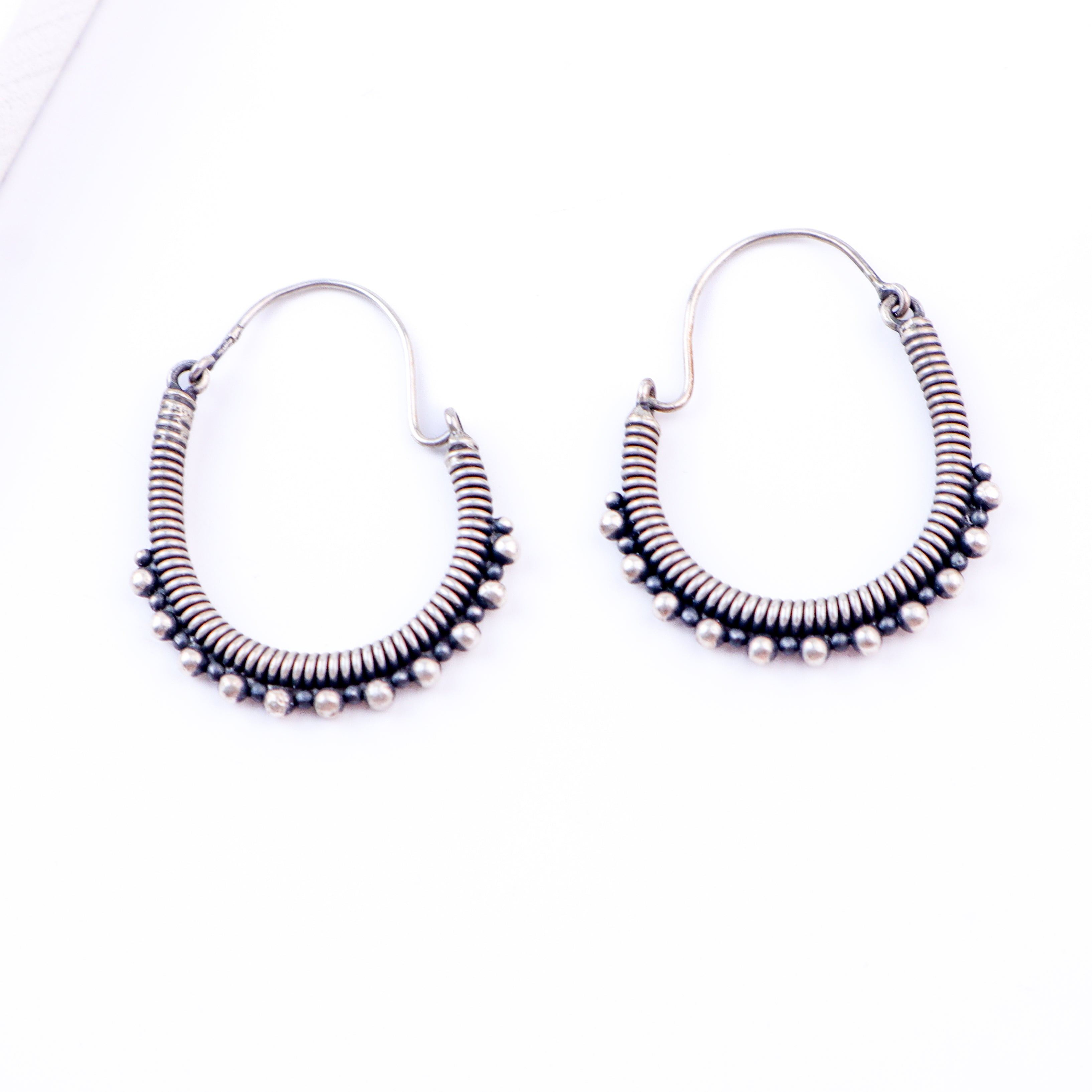Flat-lay oxidized spring hoop earrings