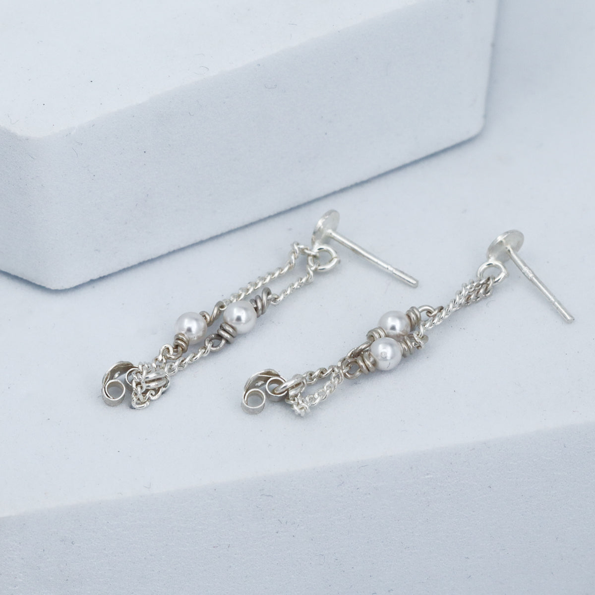 style layered pearl earrings with modern outfit